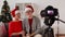 Senior couple recording christmas video on camera