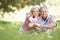 Senior Couple Relaxing In Sunny Summer Field