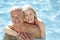 Senior Couple Relaxing In Swimming Pool Together