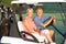 Senior Couple Riding In Golf Buggy