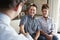 Senior Couple Shaking Hands With Male Financial Advisor At Home