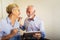 Senior couple shopping online with tablet and credit card