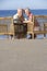 Senior Couple Sitting In Chairs Relaxing On Beach