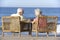 Senior Couple Sitting In Chairs Relaxing On Beach