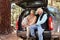 Senior couple sitting in open car trunk preparing for a hike