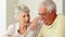 Senior couple sitting at the table using tablet pc