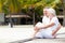 Senior Couple Sitting On Wooden Jetty