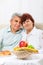 Senior couple smile having breakfast