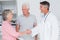 Senior couple smiling while visiting doctor