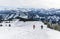 Senior couple is snowshoe hiking in alpine snow winter mountains. Allgau, Bavaria, Germany.