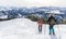 Senior couple is snowshoe hiking in alpine snow winter mountains. Allgau, Bavaria, Germany.