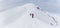 Senior couple is snowshoe hiking in alpine snow winter mountains panorama. Allgau, Bavaria, Germany.