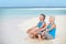 Senior Couple In Sports Clothing Relaxing On Beautiful Beach