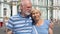 Senior couple stand on Palace Square look at camera. Pensioners travel in Saint Petersburg, Russia