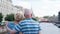 Senior couple stand on quay of canal look around. Pensioners travel in Saint Petersburg, Russia