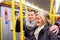 Senior couple standing in a crowded subway train