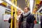 Senior couple standing in a crowded subway train