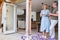 Senior Couple Standing And Looking Out Of Kitchen Door Drinking Coffee