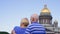 Senior couple standing near Saint Isaac`s Cathedral. Pensioners travel in Saint Petersburg, Russia