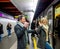 Senior couple standing at the underground platform, entering tra