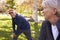 Senior Couple Stretching Whilst Exercising Together In Park