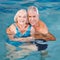 Senior couple swimming in pool