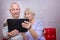 Senior couple with tablet relaxing at home.