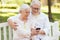 Senior couple taking selfie by smartphone at park