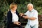 Senior couple talking on bench in park