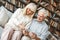 Senior couple together at home retirement concept sitting browsing smartphone touching