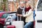 Senior couple of travellers posing with trollers