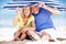 Senior Couple Under Beach Umbrella