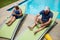 Senior couple using digital tablet on lounge chair