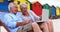 Senior couple using laptop at the beach