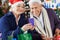Senior Couple Using Mobilephone At Christmas Store