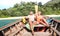 Senior couple vacationer relaxing at island hopping tour after beach exploration during snorkel boat trip in Thailand - Active