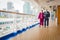 Senior Couple Walk Along Passenger Cruise Ship Deck Wearing Face Masks