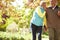 Senior Couple Walking Through Autumn Woodland