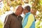 Senior Couple Walking Through Autumn Woodland