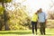 Senior Couple Walking Through Autumn Woodland