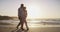 Senior couple, walking on beach and hug in sunset and married on holiday, outdoor and happy. Retirement, elderly and