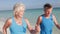 Senior Couple Walking On Beautiful Beach