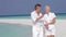 Senior Couple Walking On Beautiful Beach