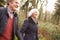 Senior Couple Walking Through Winter Countryside