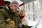 Senior couple in warm winterwear looking at paper map held by man