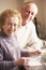 Senior Couple Washing Up At Sink