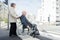 senior couple in wheelchair crossing road