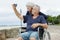 Senior couple in wheelchair taking selfie