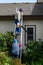 Senior couple working on fall maintenance, woman holding extension ladder while man climbs up with a gas powered leaf blower