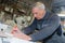 senior craftman marking tiles with pen in workshop